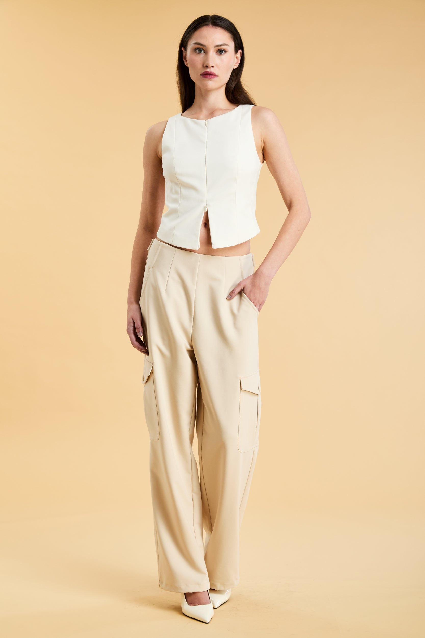 woman wearing a White Alice double ended zipper top and Almond Adelaide pant