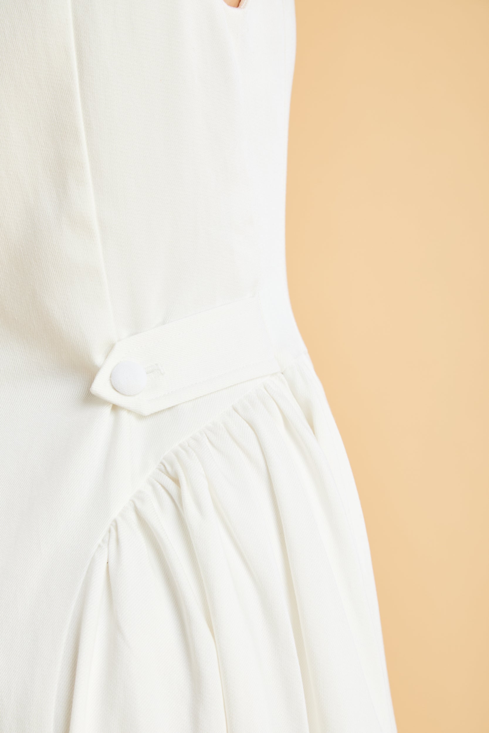 Close-up of a White dress with a beige background