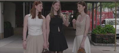 Video of identical triplets wearing matching outfits in different colors walking around New York City