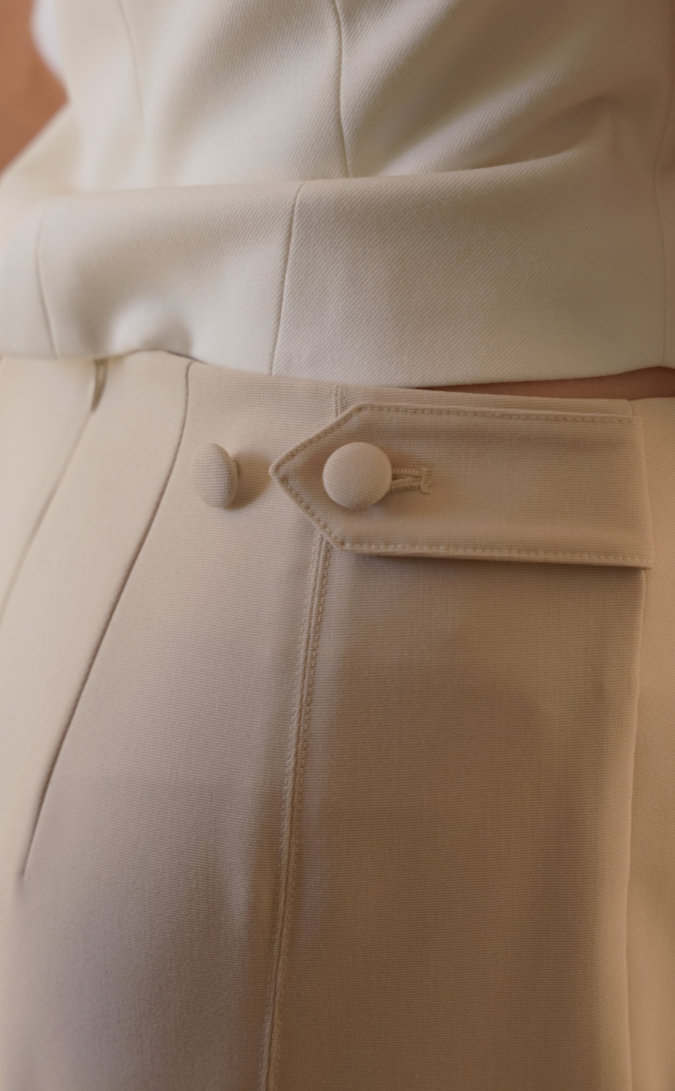close up of the Almond colored Adelaide pants with adjustable waist tabs and buttons